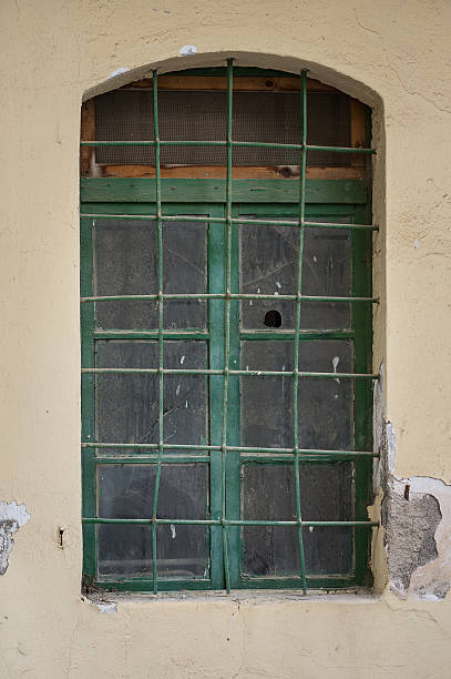 Old green window with broken glass stock photo