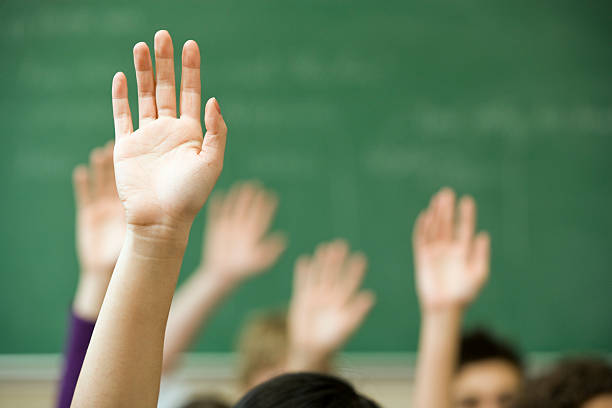 Hands raised in classroom Hands raised in classroom hand raised classroom student high school student stock pictures, royalty-free photos & images