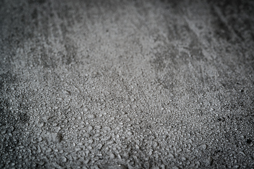 Wet concrete background with selective focus.