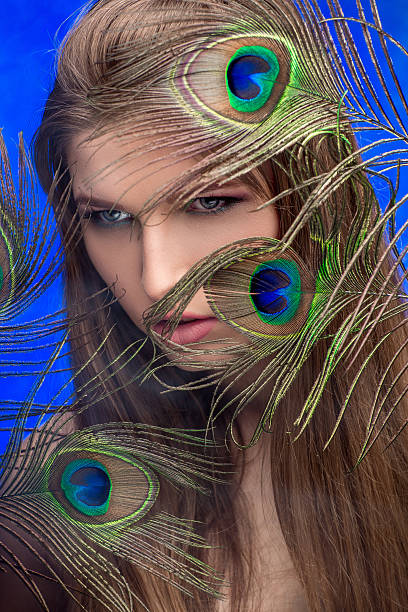 istock girl with bright  makeup and peacock feathe 522738652