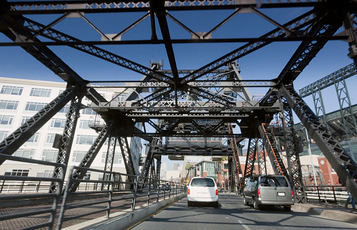 Traffic driving over Lefty O'Doul Bridge ( (also known as the Third Street Bridge or China Basin Bridge) in San Francisco's China Basin. AT&T Park to the right, home to the San Francisco Giants. Horizontal.