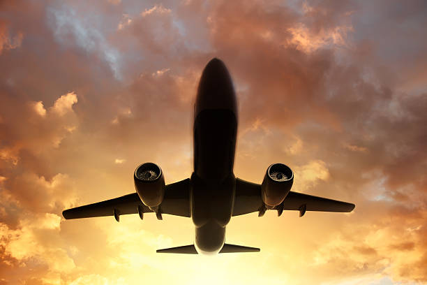istock Airplane in the sky at sunset 522739663