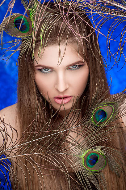 istock girl with bright  makeup and peacock feathe 522740358