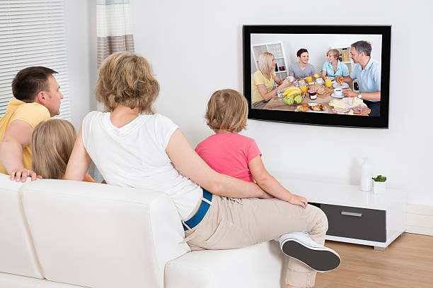 istock Young Family Watching TV Together 522740723