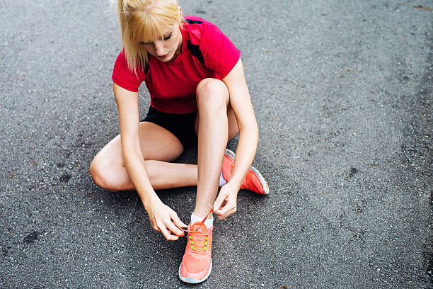 istock Female runner lacing up her shoes before the run 522740895