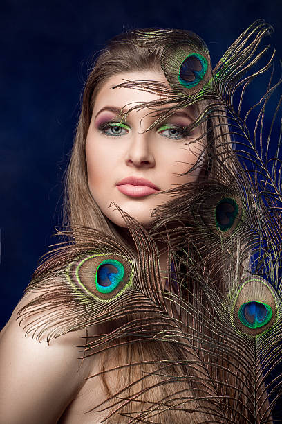 istock girl with bright  makeup and peacock feathe 522741132