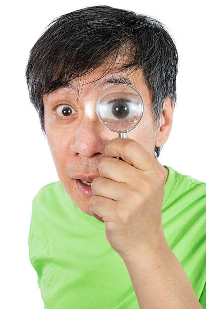 istock Asian Chinese Man Looking through a Magnifying Glass 522741344