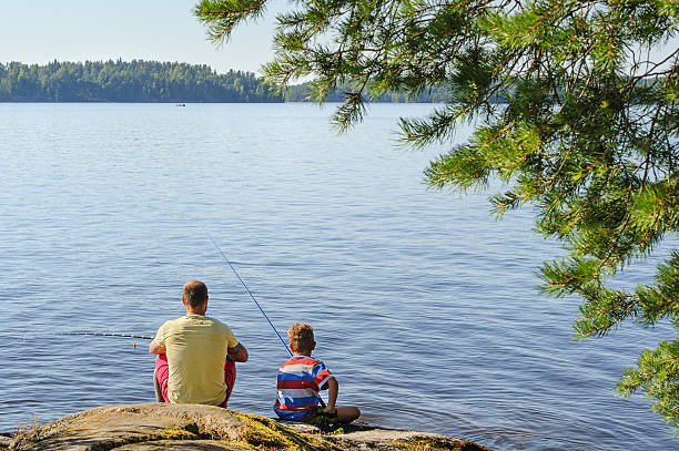 istock dad and son lake fishing 522741522