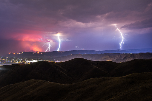 Wenatchee, WA - Aug 10th, 2013:  Lightning strikes over the city of Wenatchee, WA which causes a wild fire.  The red glow from the fire is reflected in the clouds above.