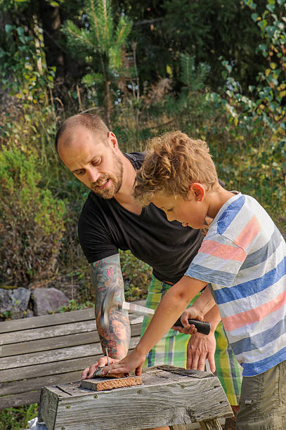 istock father teaches son to hammer 522744308