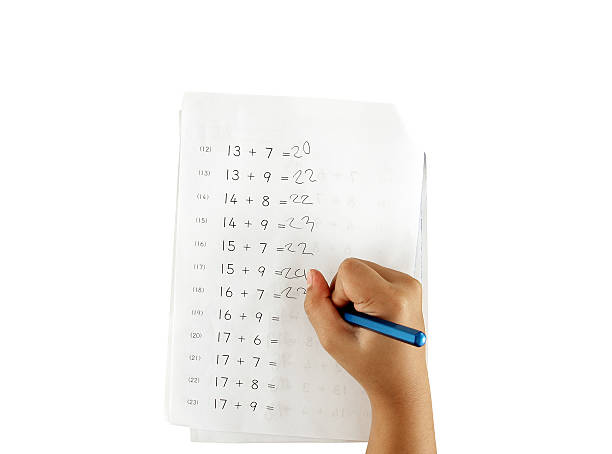 homework paper images hand of little girl doing maths homework isolated on white plus the numbers exercises of primary school children, kids education concept homework paper stock pictures, royalty-free photos & images