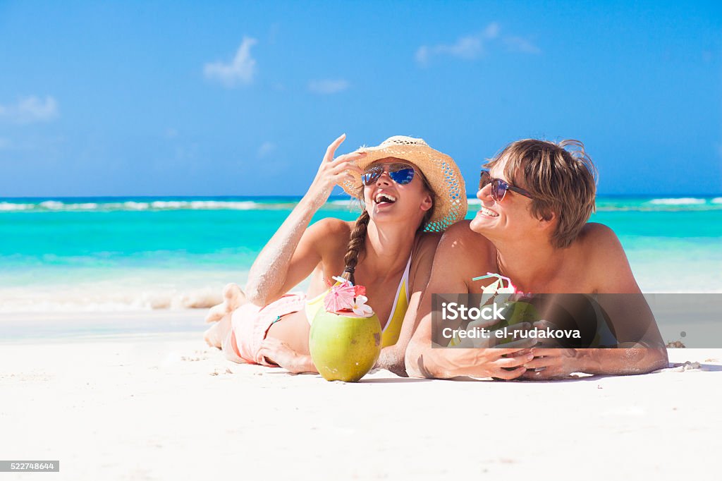 happy young couple at tropical beach in Barbados with coconuts remote tropical beaches and countries. travel concept Beach Stock Photo