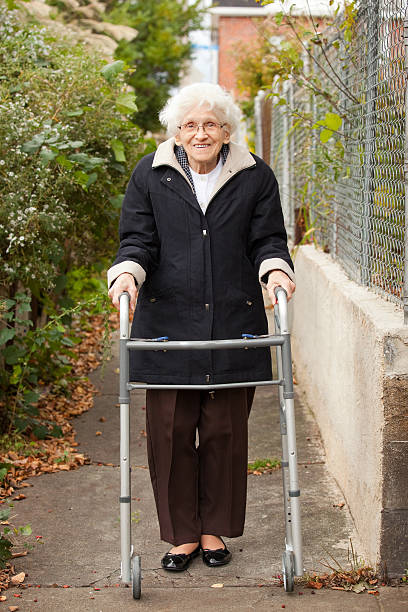 istock Senior Woman Taking Walk With Walker Outdoors 522749745