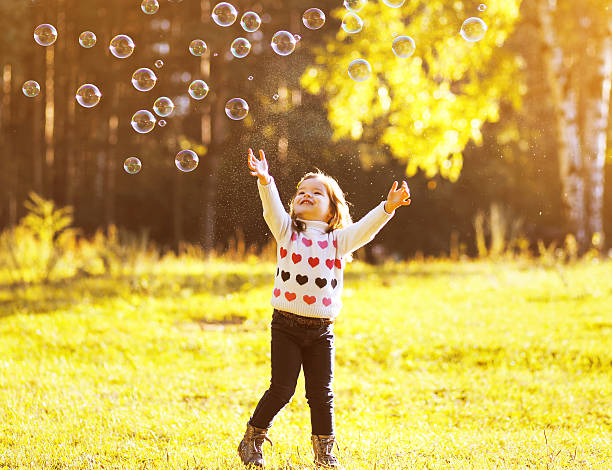istock Little child having fun with bubbles soap 522750629