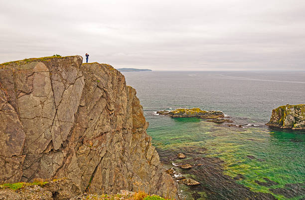 istock Observer on a Rocky Ocean Coast 522750675