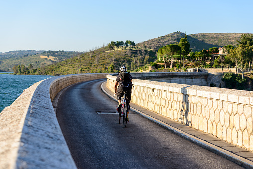 Marathon, Greece - June 16, 2012: Cyclist crossing the Marathon dam