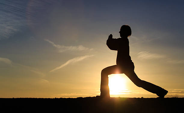 istock young man doing yoga at sunset sky 522752238