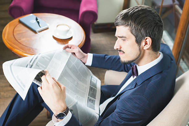 istock Businessman reading a newspaper at cafe, mourning 522752274