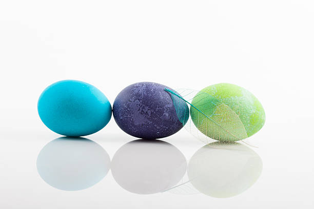 Three colored Easter eggs on white background stock photo