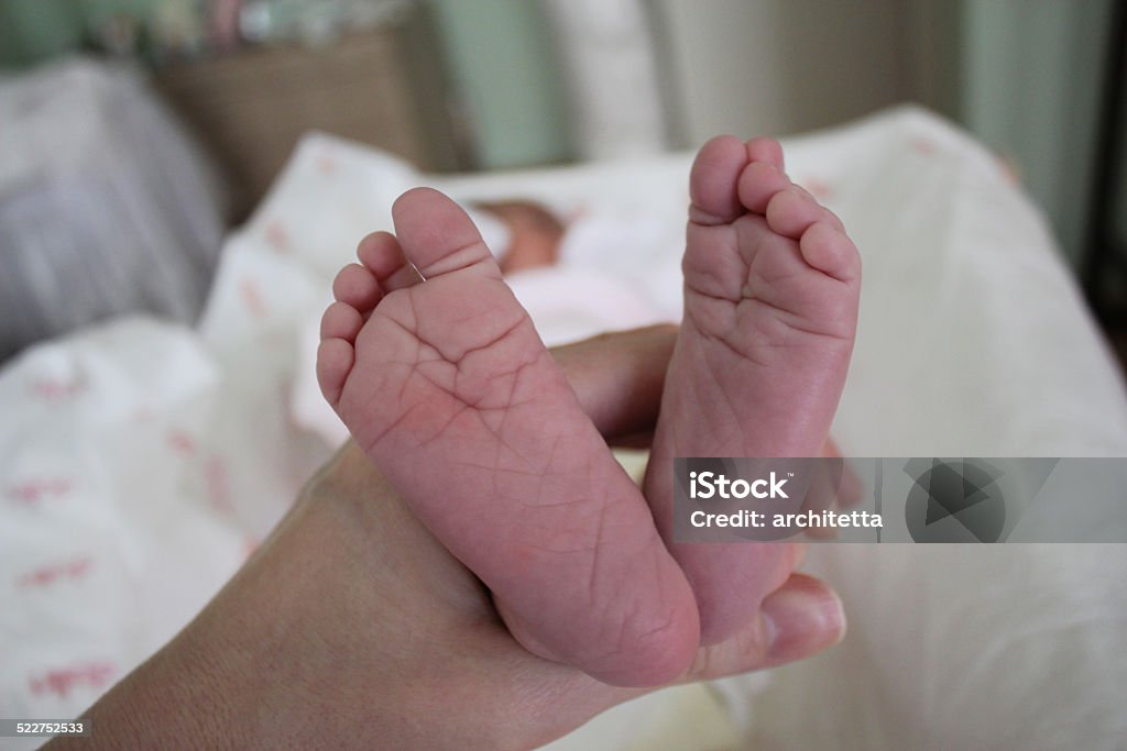 newborn baby feet newborn baby feet in mother's handsleeping newborn baby girl. baby is 2 weeks old. Baby - Human Age Stock Photo