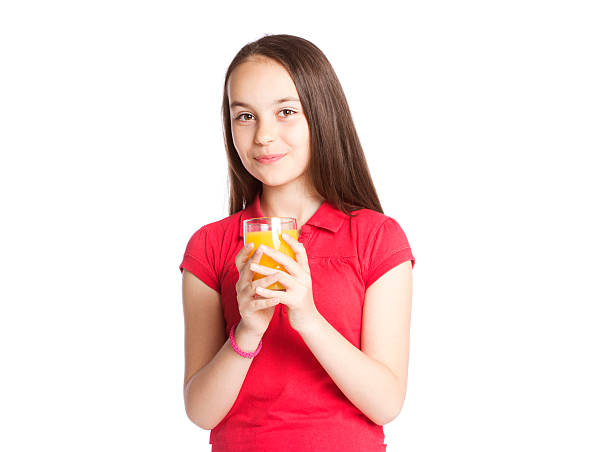 istock Cute girl drinking orange juice 522752624