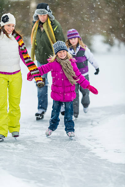 istock Family Ice-Skating on Pond 522752627