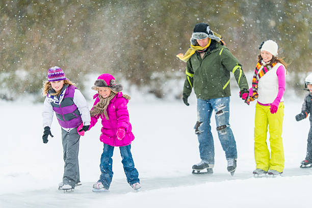 istock Family Ice-Skating on Pond 522752879
