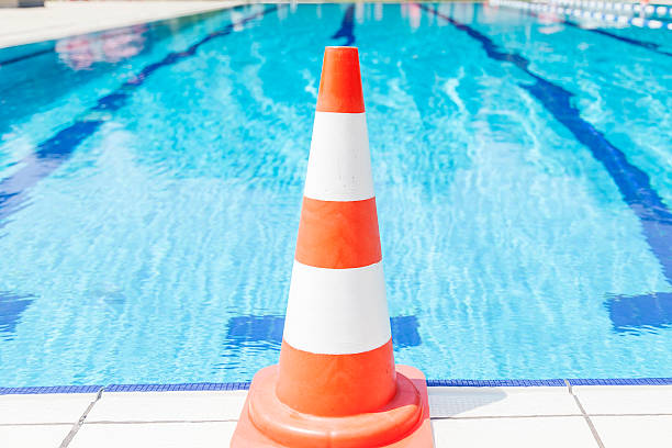 istock swimming pool repair - safety cone on edge 522753372