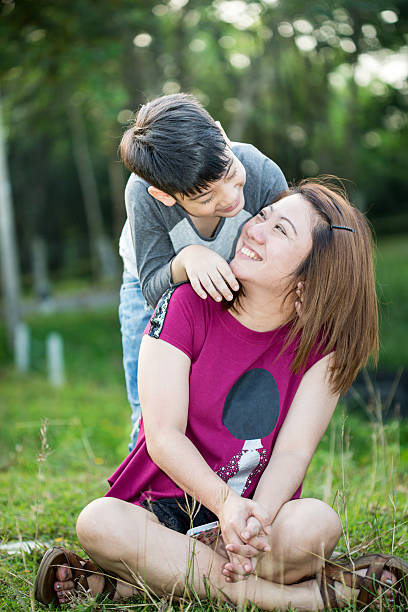 istock beautiful asian woman with your son 522753415