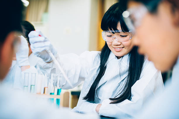 Japanese Female Student in Science Class Japanese High School girl in Science Class growing bacteria in petri dish laboratory bacterium petri dish cell stock pictures, royalty-free photos & images