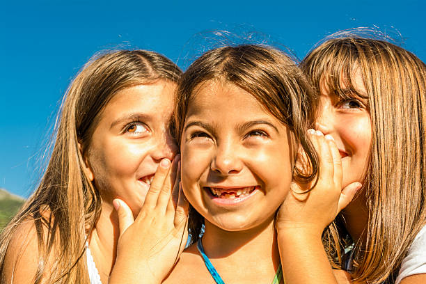 istock Three seven year old girls playing and whispering 522753771