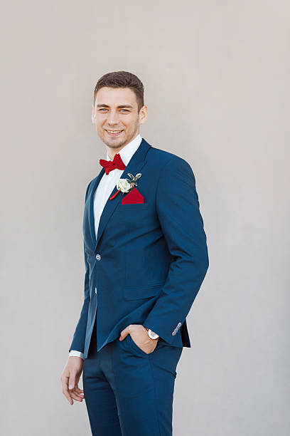 istock Smiling Groom agaist gray wall 522753874