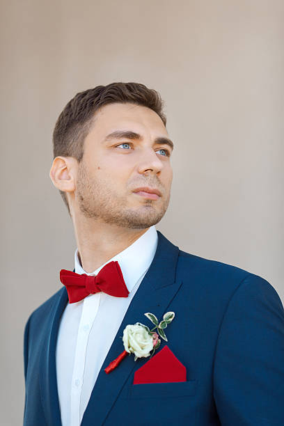 istock Serious Groom agaist gray wall 522754042
