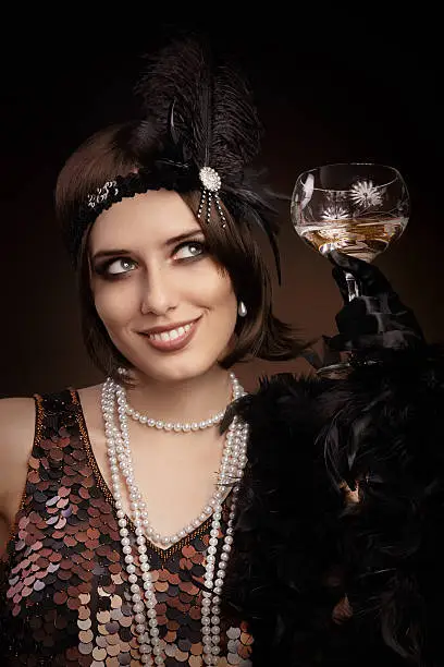 Portrait of a flapper girl with a glass of champagne