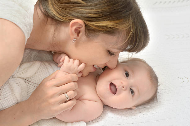 istock mother playing with baby 522754223