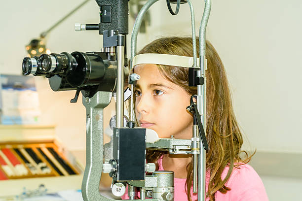 istock Little Girl taking the eye exam test 522754579
