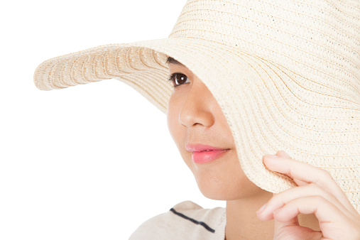 Beautiful Asian girl with sun hat  isolated on white background