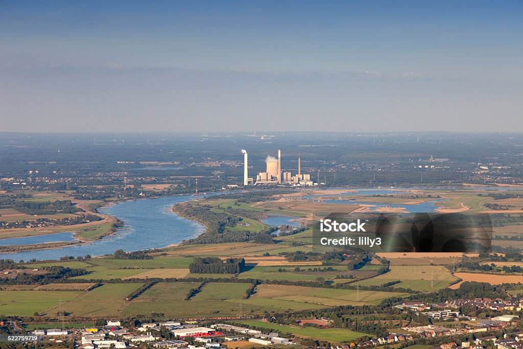 Rhine River with homes, industry and agriculture Rhine River with homes, industry and agriculture in the Lower Rhine Region of Germany - Cityscape of Rheinberg and Power Station in Voerde, North Rhine-Westfalia, Germany, Europe Aerial View Stock Photo