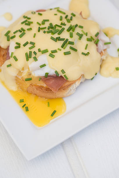 istock Eggs Benedict toasted English muffins ham poached eggs and holla 522762431