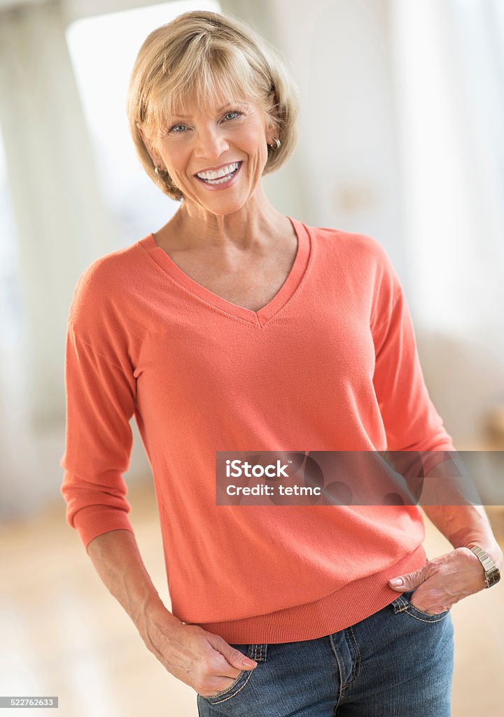 Mature Woman With Hands In Pockets Standing At Home Stock Photo - Download  Image Now - iStock