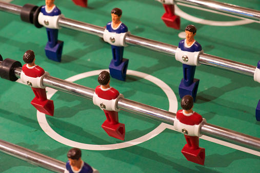 High angle shot of a foosball table zoomed in on players with out of focus areas.