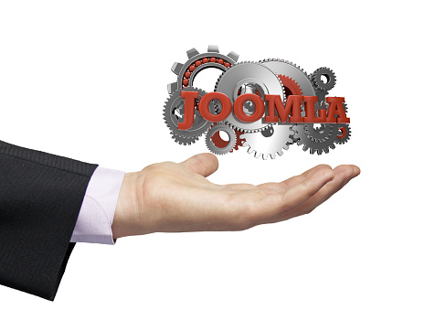 gears with text joomla over a businessman hand