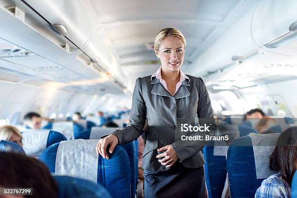 Flight Attendant In Airplane Stock Photo - Download Image Now - Air Stewardess, Service, Cabin Crew