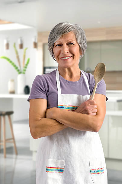 istock Happy friendly senior woman baking in the kitchen 522776040