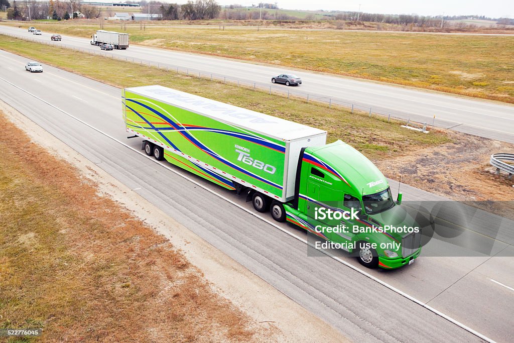 Kenworth T680 Semi Tractor and Trailer on Highway Rochester, Minnesota, USA - November 7, 2014: A Kenworth T680 Advantage semi-tractor with a matching Utility trailer with the T680 logo travels north on Hwy. 52. The T680 is claimed to be the world's most aerodynamic tractor and this is a Kenworth promotional rig. Truck Stock Photo