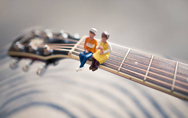 istock tiny couple listening live acoustics 522776098
