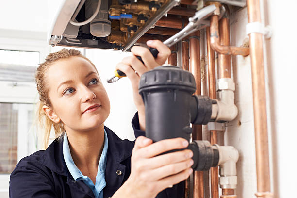 istock Female Plumber Working On Central Heating Boiler 522776150
