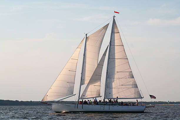 Schooner Sailing Cruise Annapolis, Maryland, USA- June 29, 2014: Woodwind Sailing Cruise sailing on the Chesapeake Bay near the  harbor at Annapolis, Maryland, USA, on the Chesapeake Bay.  The Woodwind sailboats operate daily from City Dock.  Passengers pay for an afternoon sailing excursion on the Bay. skipjack stock pictures, royalty-free photos & images