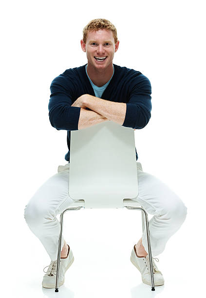istock Smiling casual man sitting on chair 522777744