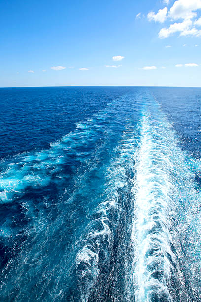 istock Trail on water surface behind of cruise ship. 522777844